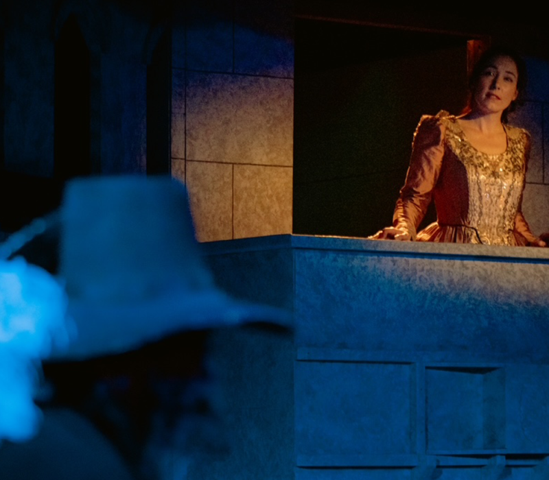 Jessica Rose Knotts as Roxane listening to poetry from the balcony in Cyrano de Bergerac at Good Company Players.